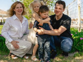 Family of four enjoying a sunny day outdoors in Kemer, smiling and spending quality time together.